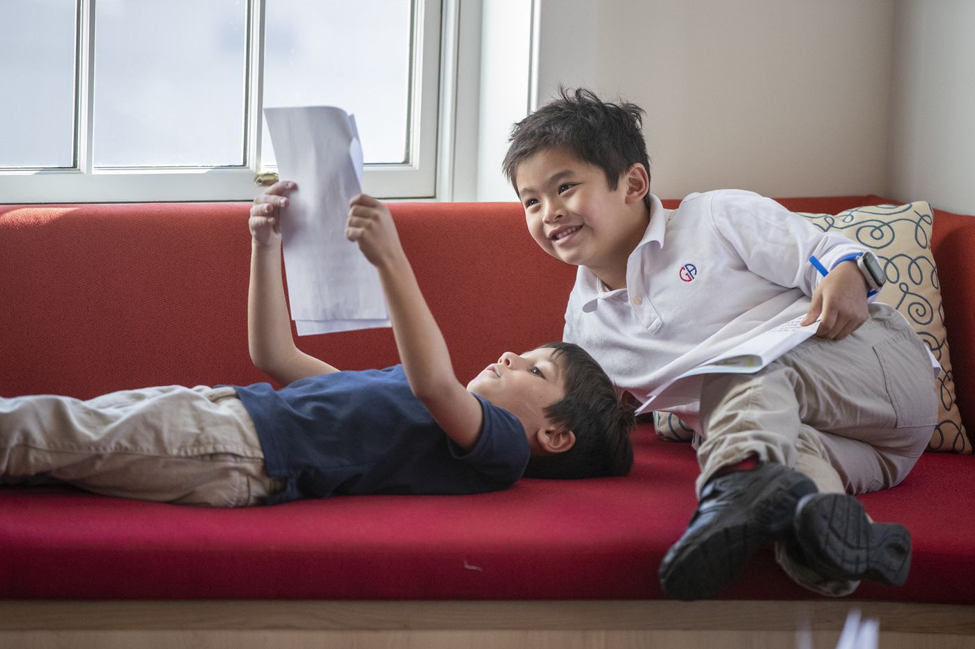 Alexander Paone, left, and Paul Bui, both 6, look over Alexander's report, in the Writers' Cafe area of the new Germantown Academy library and learning commons. The New York-based architecture firm that designed it incorporated elements from students' designs.