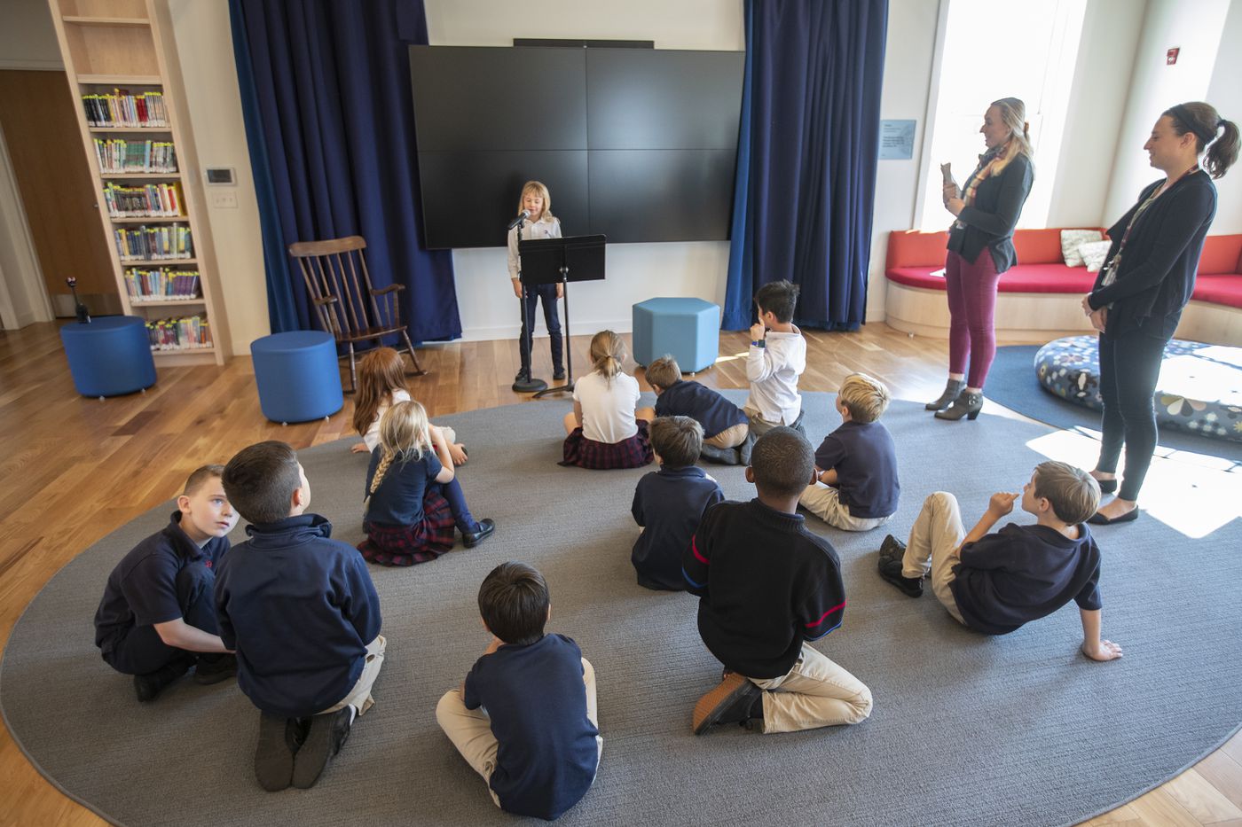 Pupils listen to a classmate read her report in the Writers' Cafe area of the new Germantown Academy library and learning commons.