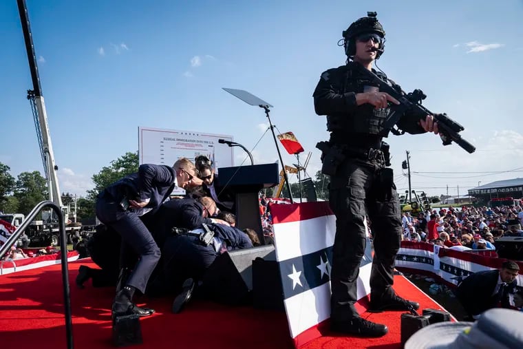 U.S. Secret Service agents and counterassault team react moments after shots were fired toward Republican presidential candidate and former president Donald Trump during a rally in Butler, Pa., on Saturday.