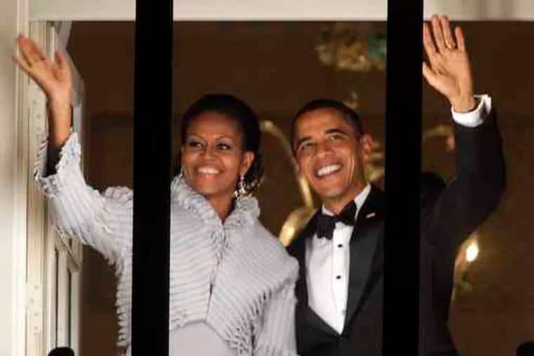 President and Michelle Obama wave to the crowd from a balcony at the Grand Hotel in Oslo after he accepted the Nobel Peace Prize at City Hall. His acceptance speech offered a lofty, ideological justification for sending more troops to Afghanistan.