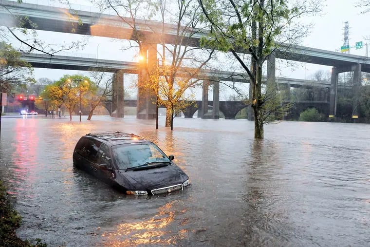 A mini van is stalled on Kelly Drive near Midvale due to Schuylkill flooding on April 30 2014. (RON TARVER / Staff Photographer )