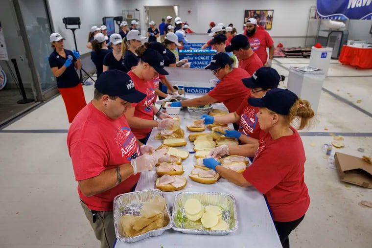 Wawa employees and volunteers work fast to make the thousands of hoagie for distribution during the 2024 Wawa Welcome America Hoagie Day.