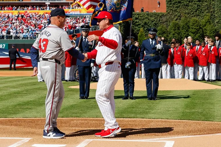 Atlanta Braves manager Brian Snitker (left) and Phillies manager Rob Thomson shake hands on opening day in March. Will they meet again in the postseason?