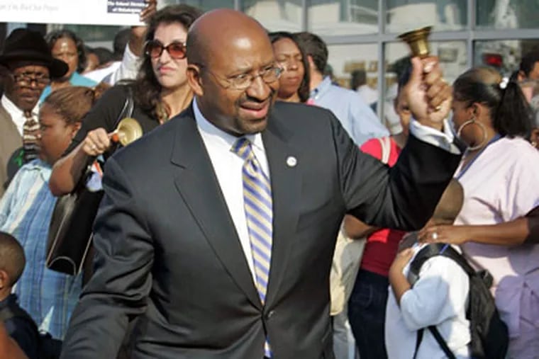 Philadelphia Mayor Michael Nutter rings a bell to signal the start of school at the new Commodore Barry Elementary School in Philadelphia on the first day of class Thursday. (Laurence Kesterson / Inquirer)