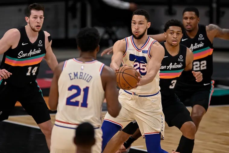 The Sixers' Ben Simmons (25), who scored the winning basket, passes to teammate Joel Embiid (21), who had 34 points and 12 rebounds. San Antonio's  Keldon Johnson (3), Drew Eubanks (14), and Rudy Gay defend on the play.