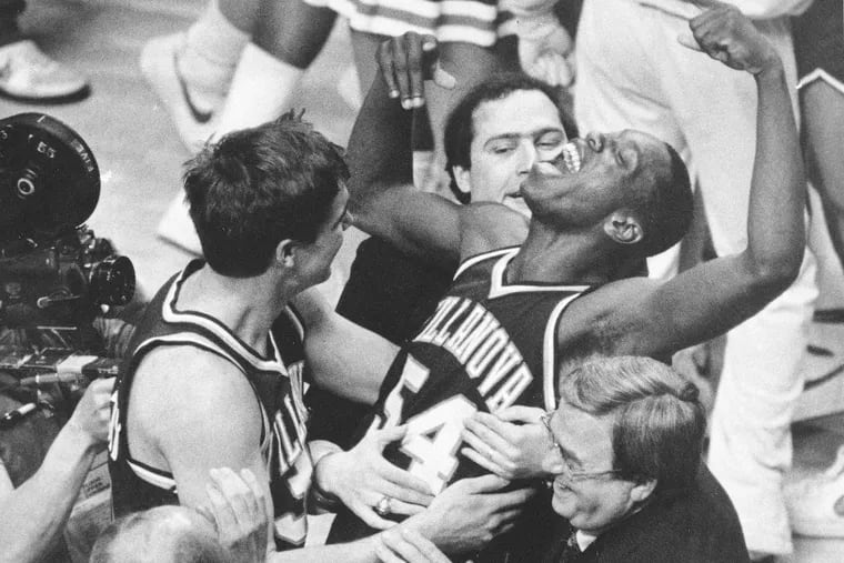 FILE - In this April 1, 1985, file photo, Villanova's Ed Pinckney (54) yells out as he is surrounded by teammates after defeating Georgetown 66-64 in the National Championship game. Dr. Ted Aceto, the university athletic director who brought Villanova into the Big East and saw the program rise into a college basketball powerhouse, died Thursday at 82. (AP Photo/Gary Landers, File)