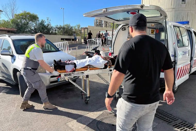 Civil Defense first-responders carry a wounded man whose handheld pager exploded at al-Zahraa hospital in Beirut, Lebanon, on Tuesday, Sept. 17, 2024.