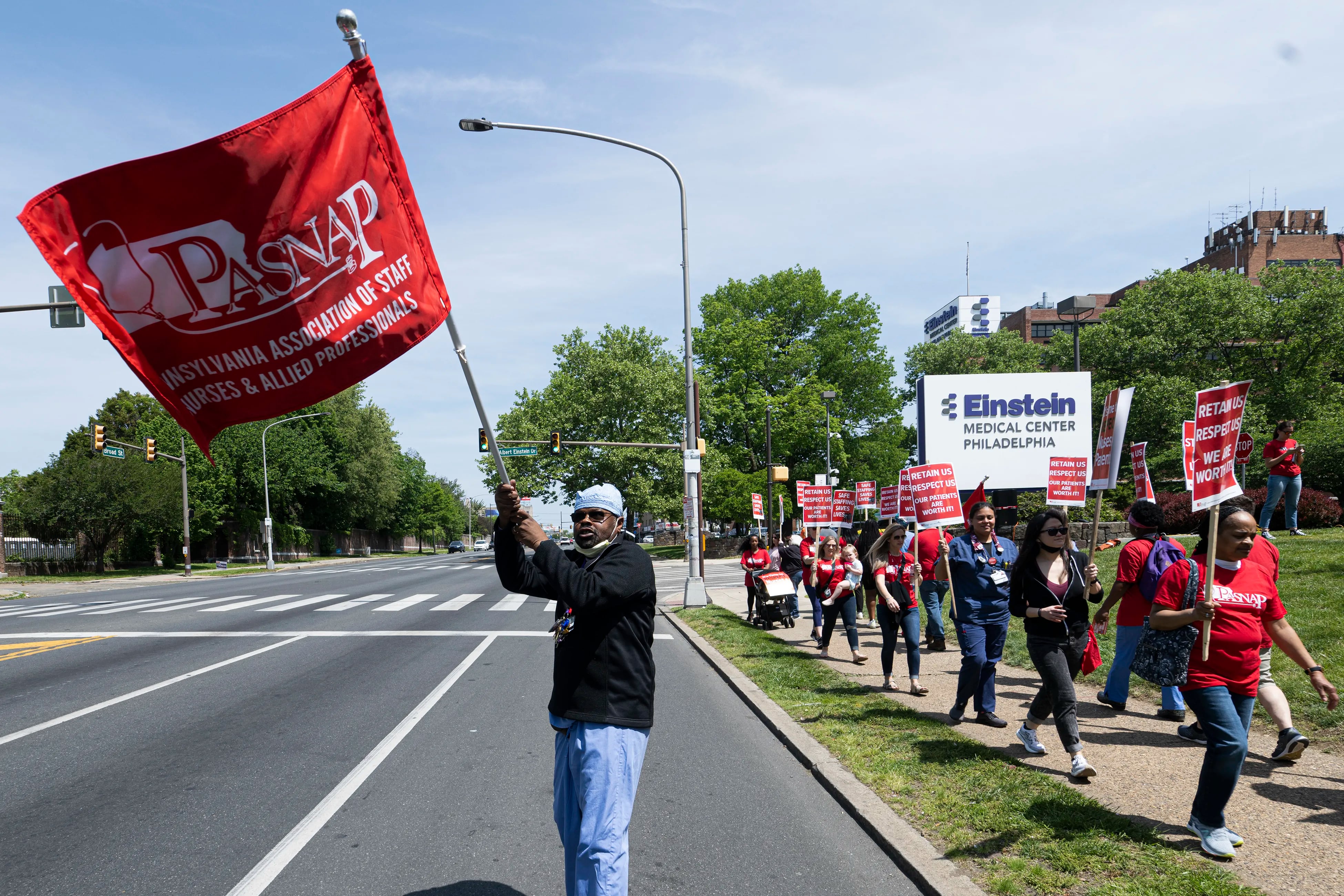 Patrick Campbell waves a flag during a rally along other health professionals on May 11 outside the Albert Einstein Medical Center in Philadelphia while Einstein nurses were in contract negotiations.