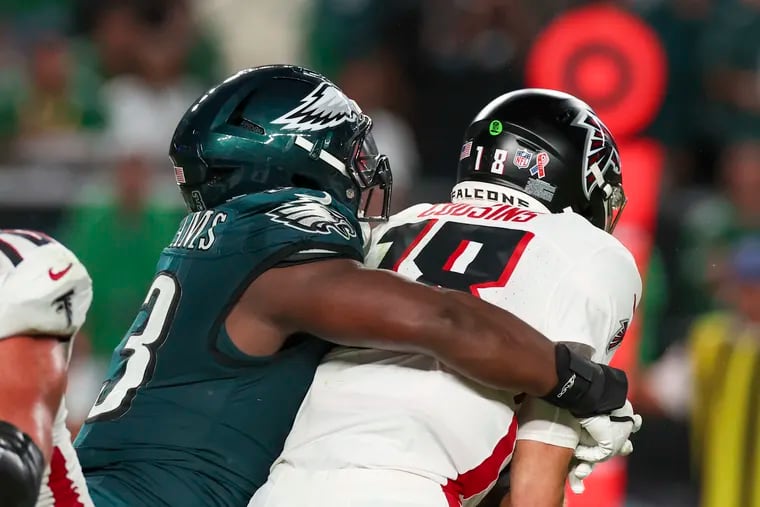 Atlanta Falcons quarterback Kirk Cousins gets sacked by Eagles defensive tackle Milton Williams  during the third quarter at Lincoln Financial Field.