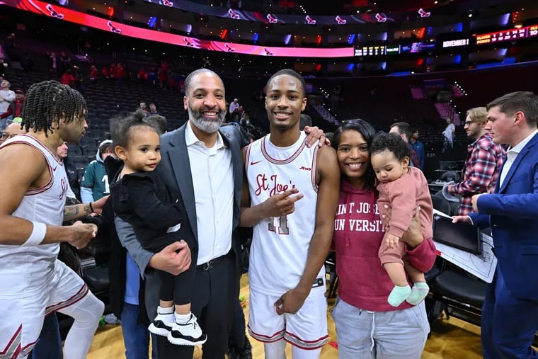 Xzayvier Brown with his stepfather, Justin Scott, and mother, Amber, after St. Joseph's won the inaugural Big 5 Classic in December.