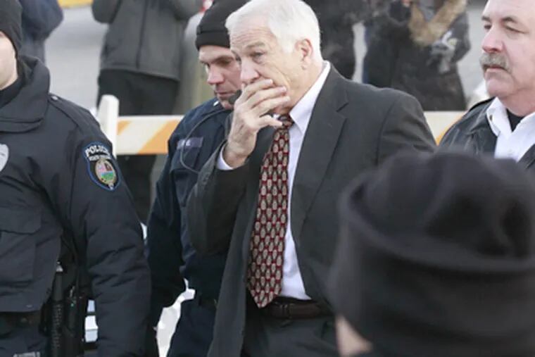 Former Penn State coach Jerry Sandusky is escorted into court. His attorney called waiving the preliminary hearing on child-sex-abuse charges "a tactical measure." (David Swanson / Staff Photographer)