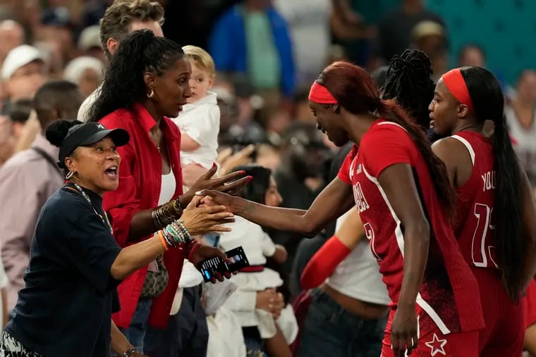 Dawn Staley celebrates with Kahleah Copper and the United States players after they beat France for the gold medal.