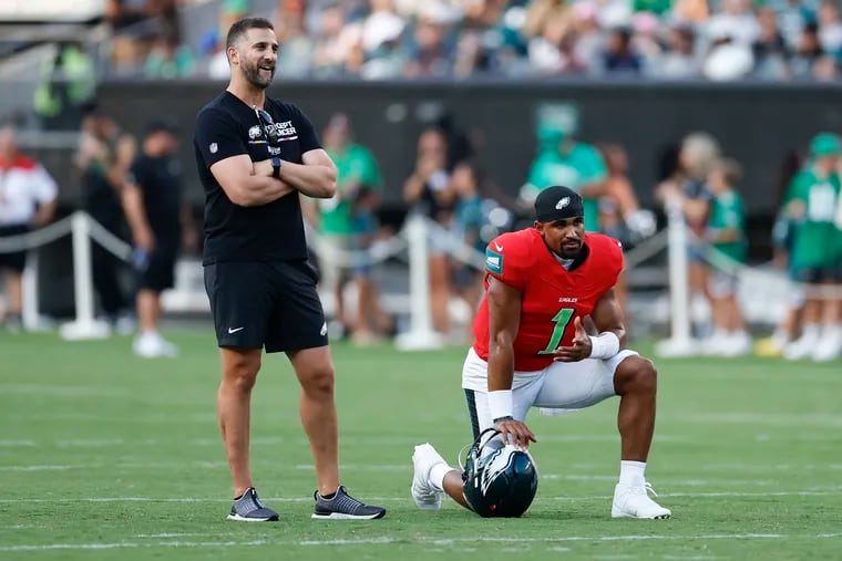 The dynamic between Eagles quarterback Jalen Hurts (right) and head coach Nick Sirianni has been a major storyline during training camp.