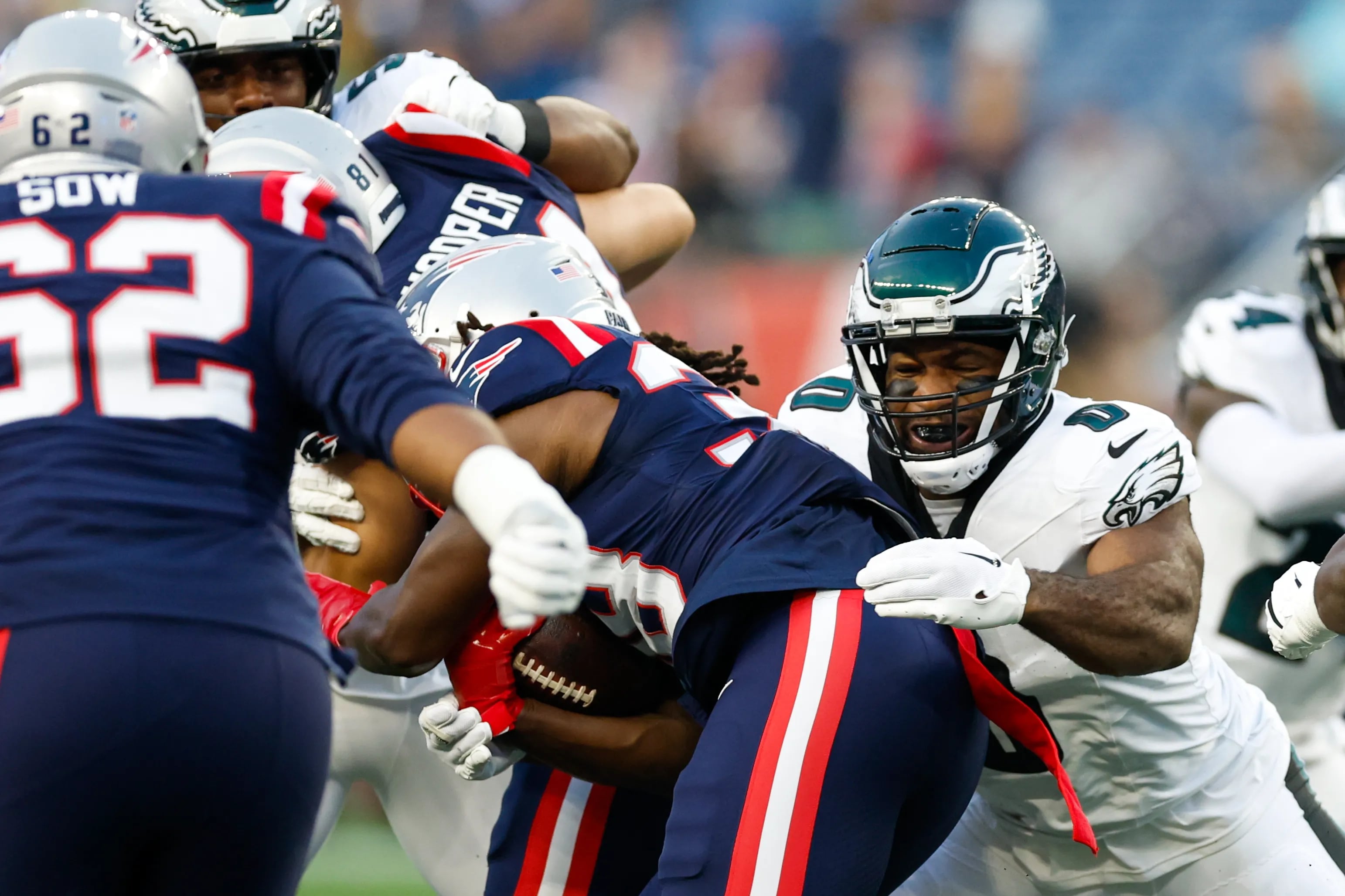 Eagles defensive end Bryce Huff stops New England Patriots running back Rhamondre Stevenson in a preseason game on Aug. 15.