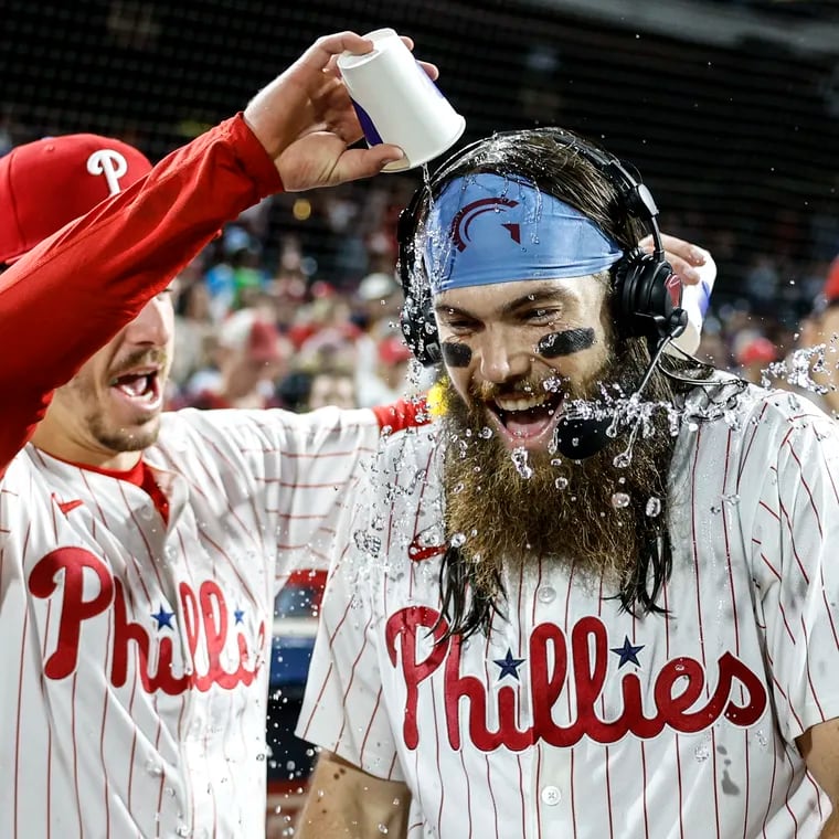 Phillies Bryson Stott left gives Brandon Marsh a water bath after they beat the Cubs 9-6 at Citizens Bank Park in Philadelphia, Wednesday, September 25, 2024