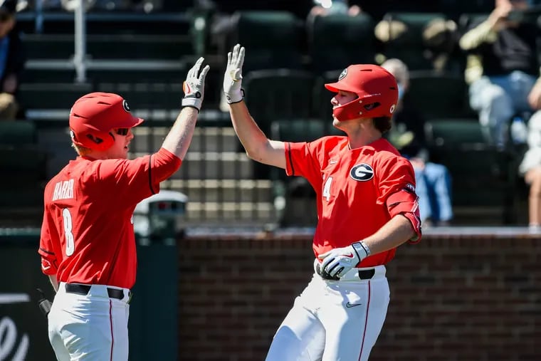 Charlie Condon #24 and Parks Harber #8 of the Georgia Bulldogs high-five after scoring a run against the Vanderbilt Commodores at Hawkins Field on April 1, 2023 in Nashville, Tennessee. (Photo by Carly Mackler/Getty Images)