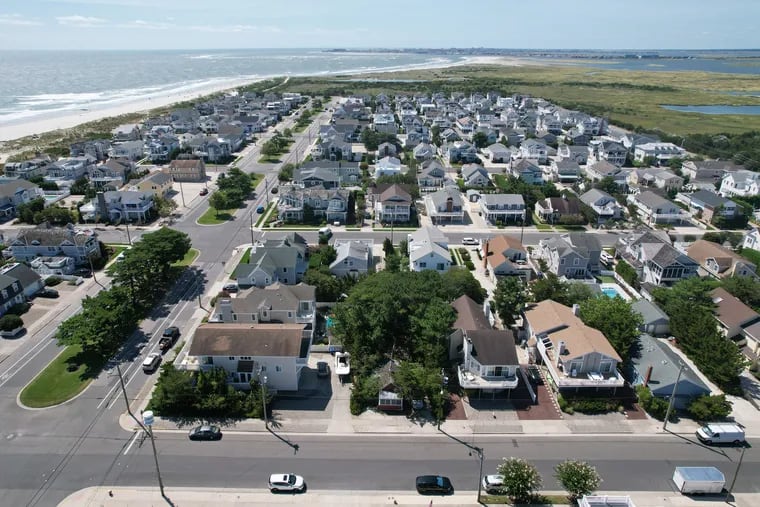 Linda Galer and William Flynn's red bungalow is nestled in the trees on their Stone Harbor, N.J., property. It stands out among the many multimillion-dollar homes on Seven Mile Island.