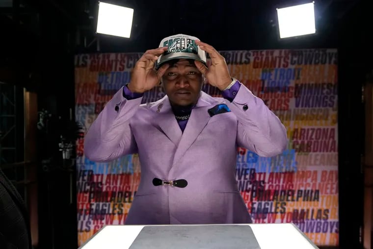 Georgia defensive lineman Jalen Carter puts on a hat after being chosen by the Philadelphia Eagles with the ninth overall pick during the first round of the NFL football draft, Thursday, April 27, 2023, in Kansas City, Mo.