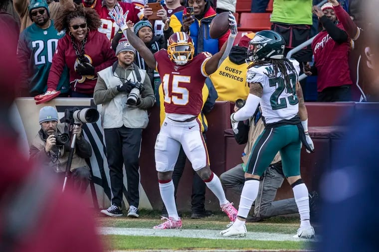 Washington Redskins receiver Steven Sims (left) celebrates his second-quarter touchdown catch over Avonte Maddox in the Eagles' 37-27 win Sunday at FedEx Field.
