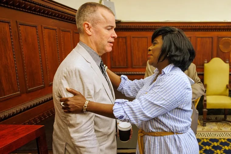 Mayor Cherelle L. Parker greets Managing Director Adam Thiel inside City Hall in June. Thiel, the city's former fire commissioner, earns income from two consulting firms he cofounded.