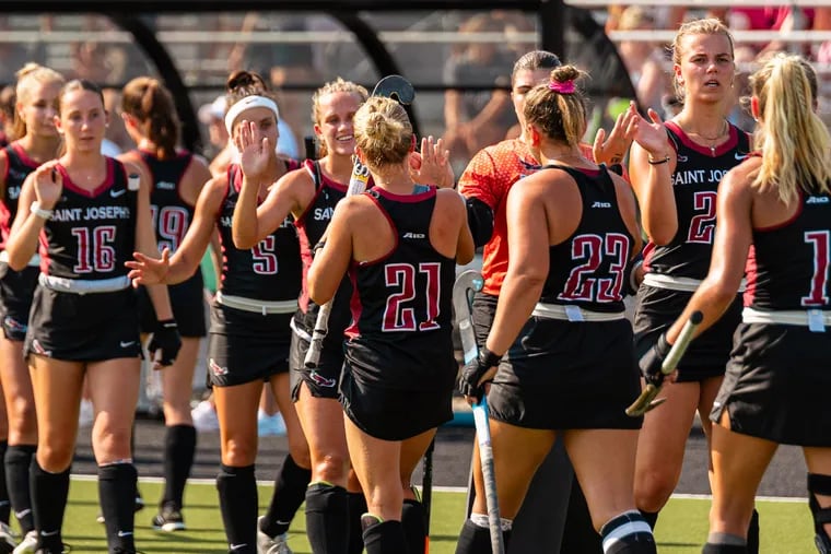 The St. Joe's field hockey team celebrates after a game earlier this season.