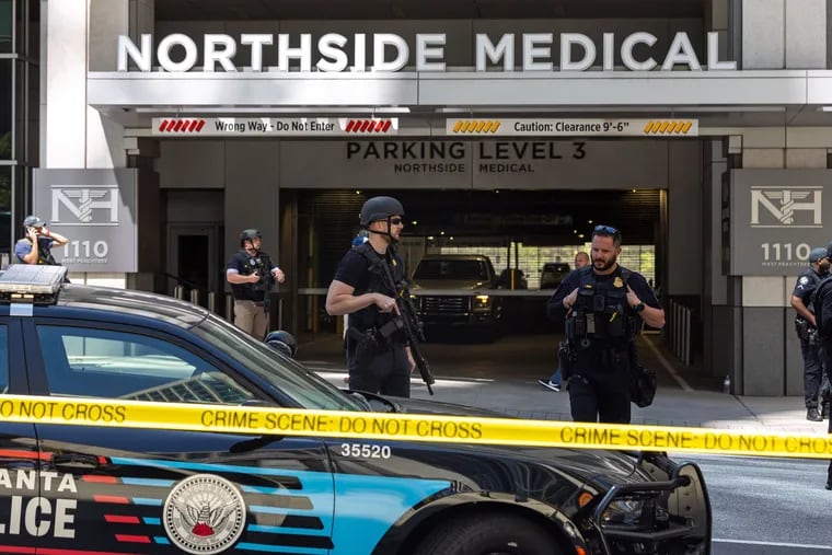 Police stand outside the Northside Medical office building, where five people were shot, one fatally, on May 3 in Atlanta.