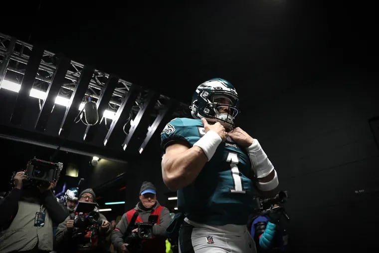Philadelphia Eagles quarterback Jalen Hurts is trailed by television cameras as he exits the players' tunnel before the Eagles play a playoff game at Lincoln Financial Field. Their quest to return to the Super Bowl begins Sunday.