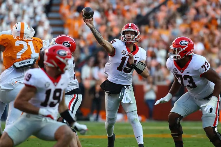 Georgia quarterback Carson Back makes a first down pass completion during an NCAA college football game against Tennessee, Saturday, Nov. 18, 2023, in Knoxville, Tenn. (Curtis Compton/Atlanta Journal-Constitution via AP)