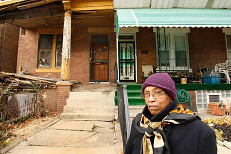 Mary Green lives next to an abandoned house - for now. (David Maialetti / Staff Photographer)