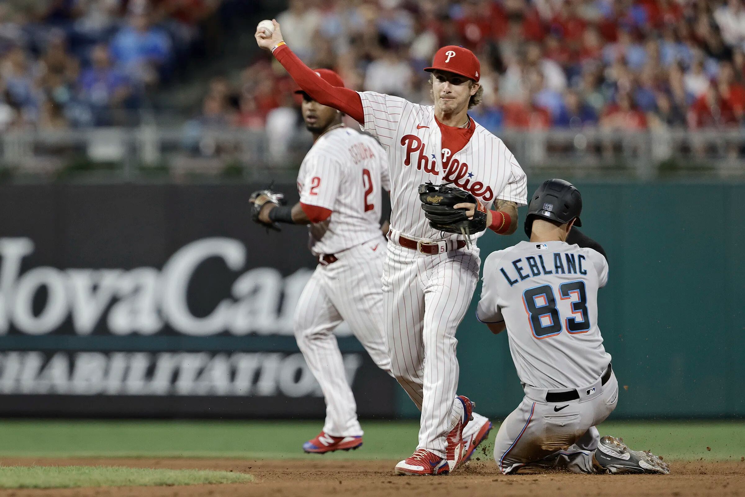 Philadelphia Phillies - The team celebrating winning today's game. They are  wearing white Phillies uniforms and hugging Bryson Stott.