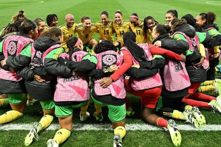 Jamaica's players kneel together on the field before Tuesday's women's World Cup round of 16 game against Colombia, the first knockout-round World Cup game in the nation's history.