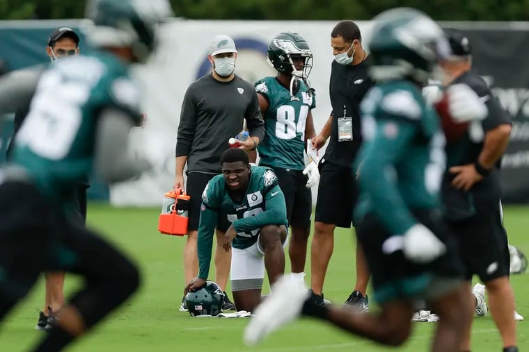 Eagles wide receiver Jalen Reagor takes a knee while watching practice at the NovaCare Complex in South Philadelphia on Friday, Sept. 11. The rookie will play in Sunday's opener against Washington.