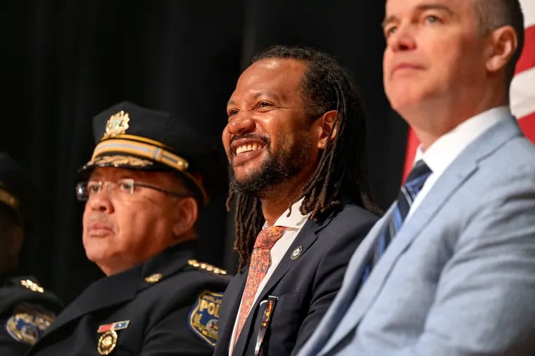 Philadelphia Police Commissioner Kevin J. Bethel (left) sits next to Philadelphia Public Safety Director Adam Geer and Managing Director Adam Thiel at a police academy graduation in June.
