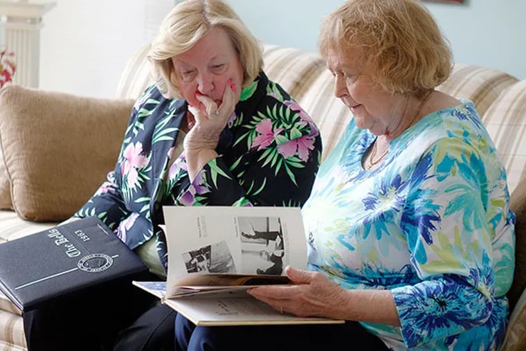 Maureen Zrasz, left, and Mary Francescone, 82, look at a 1949 St. Mary of the Angels Academy yearbook on Wednesday, May 7, 2014. ( AKIRA SUWA  /  Staff Photographer )