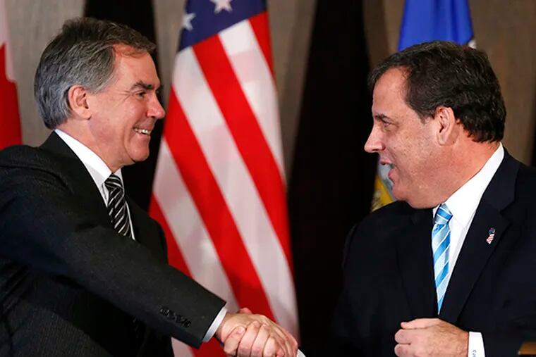 New Jersey Gov. Chris Christie, right, shakes hands with Alberta Premier Jim Prentice during a meeting in Calgary, Alberta, Canada on Thursday, Dec. 4, 2014. (AP Photo/The Canadian Press, Larry MacDougal)
