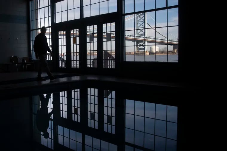 Homeowner Steven Peikin is silhouetted in the pool area of the Pier 3 Condominium building in Philadelphia.