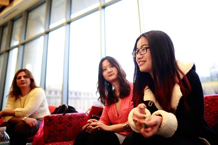 Brisilda Doma, 37, Albania, Weiqi Lin, 24, China and Ying Ying Zhang, 20 talk about how they will spend the holidays away from home and on the Temple campus Monday December 23, 2013. ( DAVID SWANSON / Staff Photographer )