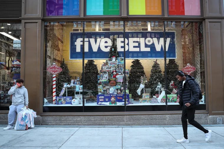 A pedestrian walks by the Five Below store in Philadelphia. Five Below recently announced higher prices for certain products. The company and other retailers are dealing with the Trump administration's tariffs on goods from China.