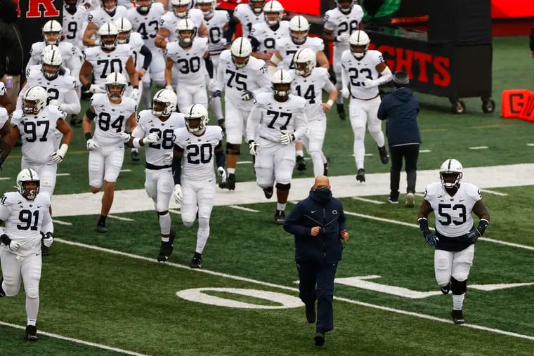 Penn State head coach James Franklin, shown leading his team on to the field to face Rutgers last season, has received oral commitments from four players for his freshman class of 2022. (AP Photo/Adam Hunger)