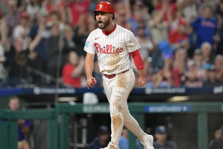 Philadelphia Phillies' Cal Stevenson, scores after hitting a RBI double off Tampa Bay Rays' Edwin Uceta during the eighth inning of a baseball game, Tuesday, Sept. 10, 2024, in Philadelphia.