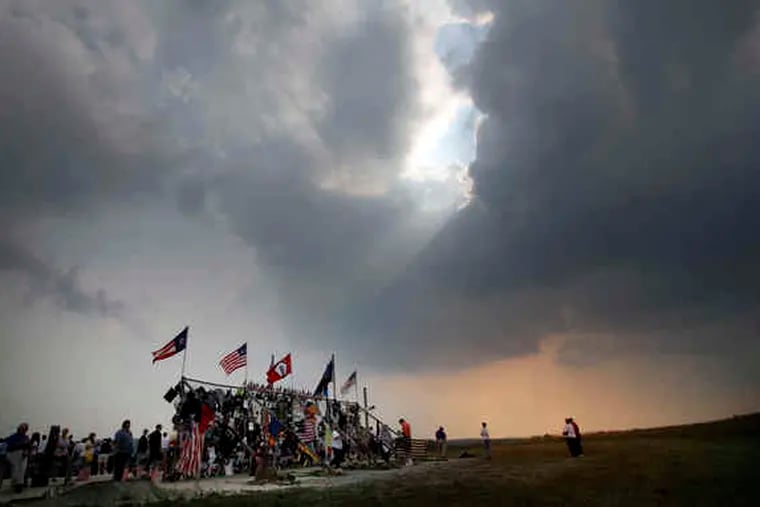 2006: The late-afternoon sun peeks through the clouds at a temporary memorial at the crash site on the day before the fifth anniversary.