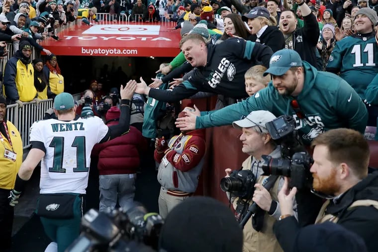Eagles fans cheer for quarterback Carson Wentz (11) as he leaves the field after Sunday's win over the Washington Redskins.