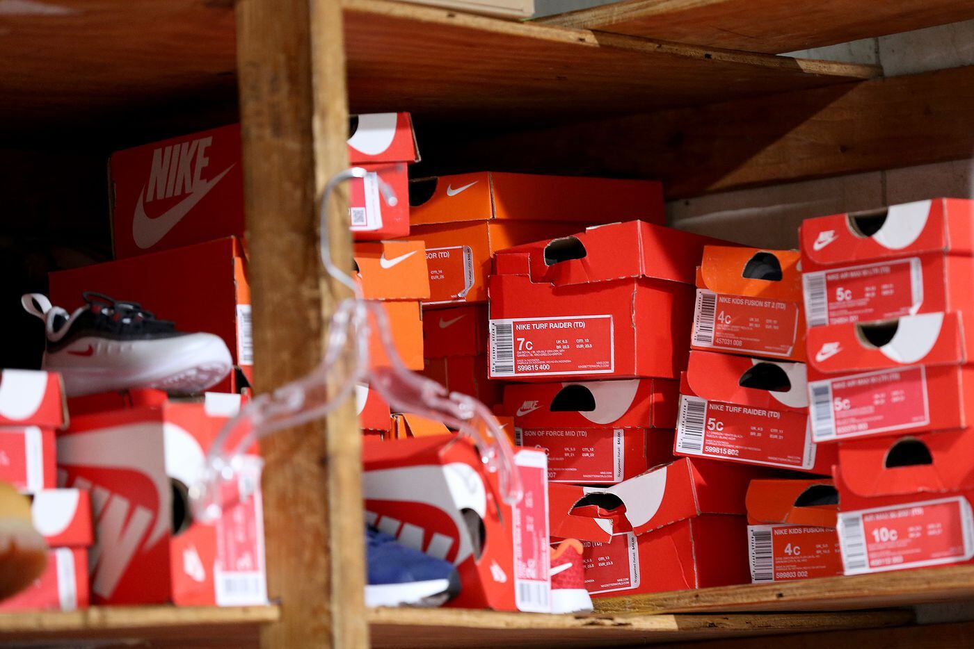 Boxes of Nike shoes sit on a shelf in the storage area in Young's Sneaker City.