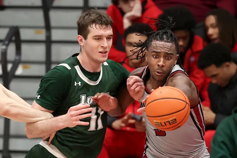 Cameron Brown (right) of St. Joseph's strips the ball away from Milos Ilic of Loyola of Maryland in December.