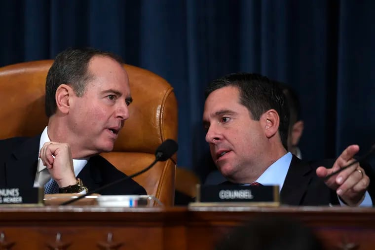 House Intelligence Committee Chairman Adam Schiff (left, D-Calif.) talks with ranking member Devin Nunes (R-Calif.) during the House Intelligence Committee impeachment hearing on Wednesday.