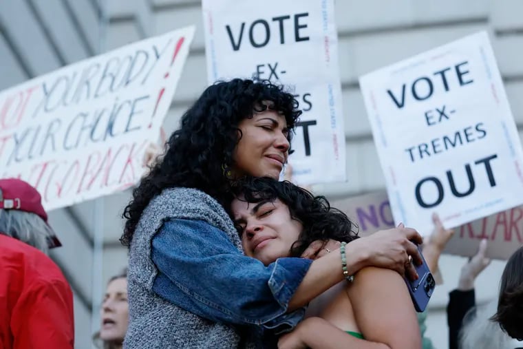 Mitzi Rivas, left, hugs her daughter Maya Iribarren during an abortion-rights protest at City Hall in San Francisco following the Supreme Court's decision to overturn Roe v. Wade, on Friday.