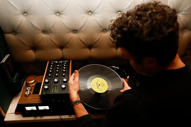 Noah Marmar, also know as “DJ on Mars,” prepares to play a vinyl record at 48 Record Bar, a vinyl centric cocktail bar in Old City on Thursday, Feb. 29, 2024.