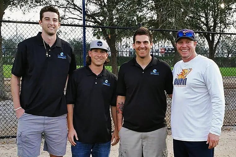 Roy Halladay (right) with (from left) Phillies minor leaguers Kyle Young and Jeff Singer and former minor leaguer Scot Hoffman.