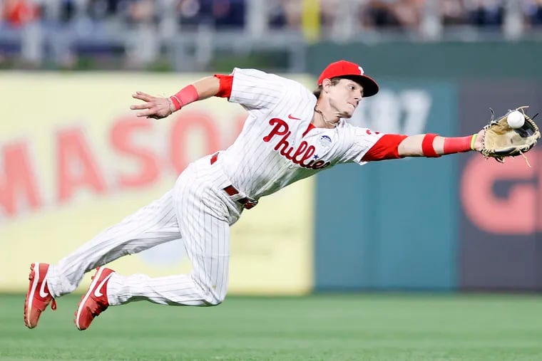 Phillies Nick Maton dives to catch Angels Mike Trout's line drive.