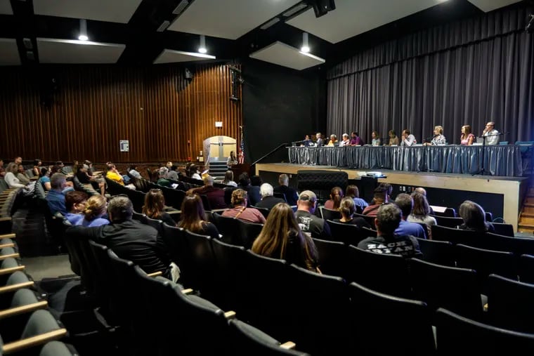 The Wallingford Swarthmore School District board of directors listens to members of the public after voting to approve the separation agreement for Wagner Marseille, who is leaving the district after facing complaints about alleged poor treatment of staff members.